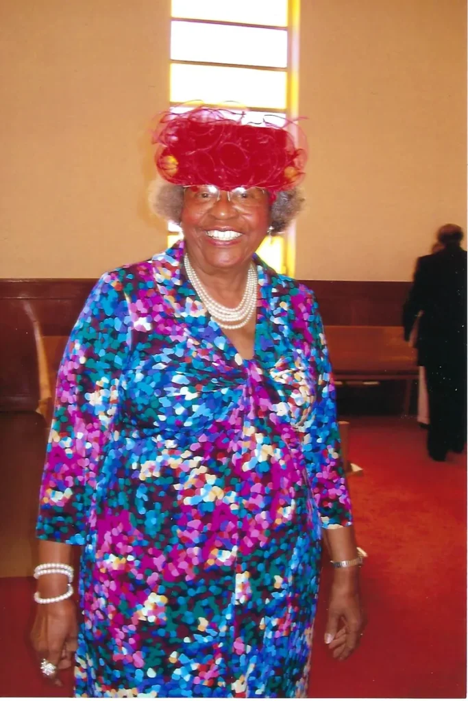 Dolores at church in a red hat