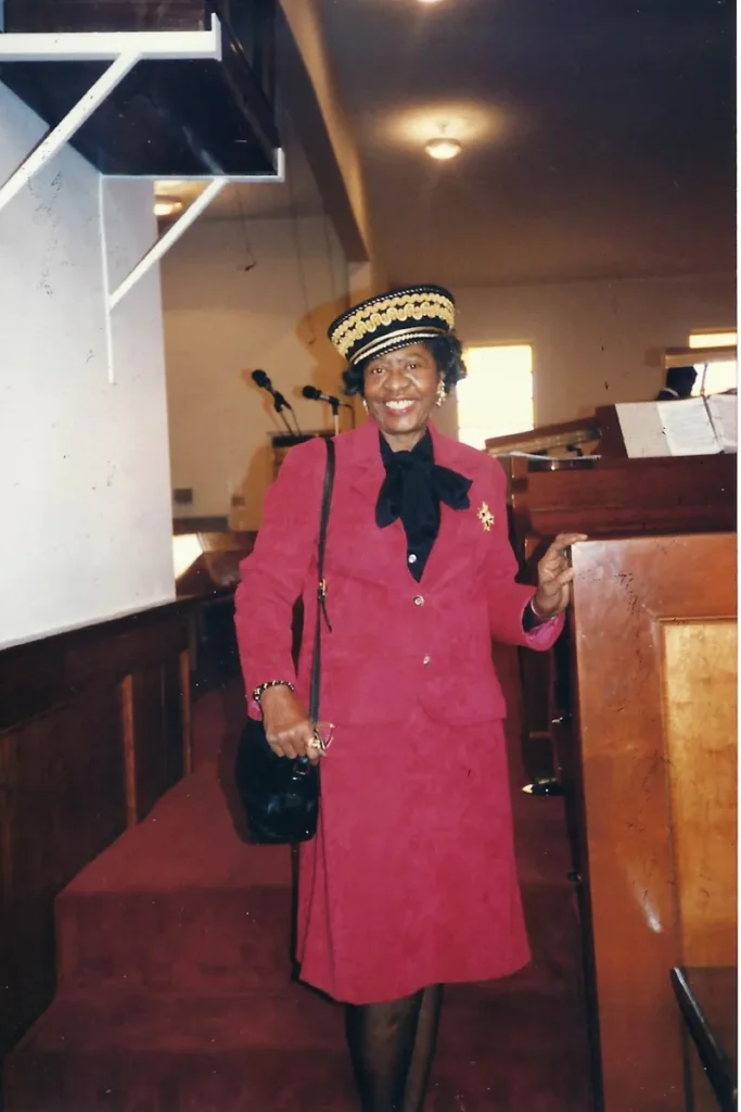 Dolores at church in a red suit