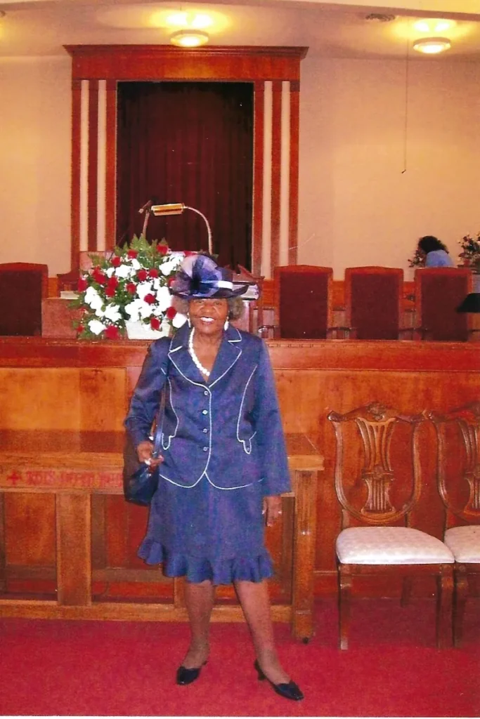 Dolores at church in a navy suit